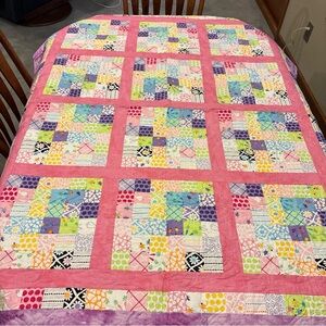 Vibrant Patchwork Quilt with Pink and Purple Accents